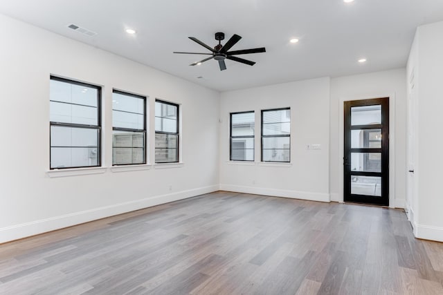 empty room featuring ceiling fan, recessed lighting, wood finished floors, visible vents, and baseboards