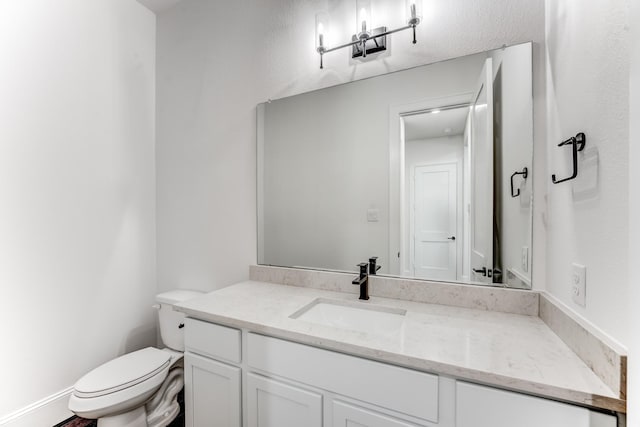 bathroom featuring toilet and vanity