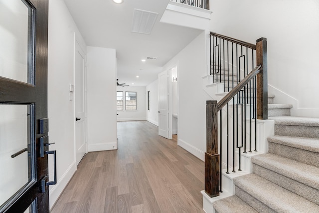 entrance foyer featuring light wood-style flooring, recessed lighting, visible vents, baseboards, and stairs