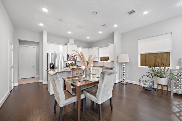 dining area with dark wood-style floors, recessed lighting, visible vents, and baseboards