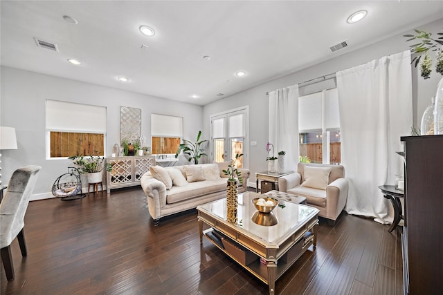 living room with recessed lighting, dark wood-style flooring, and visible vents