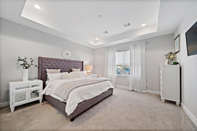 carpeted bedroom featuring recessed lighting, a raised ceiling, visible vents, and baseboards