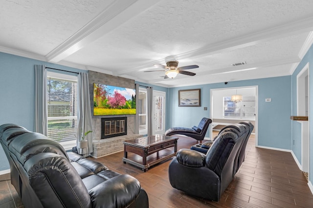 living room featuring a brick fireplace, crown molding, a textured ceiling, and wood finished floors