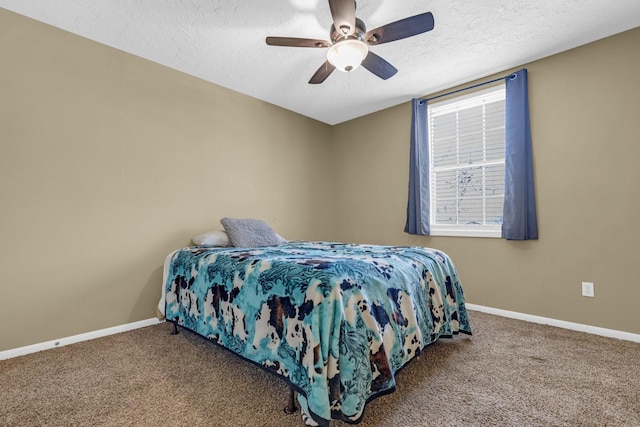 carpeted bedroom featuring a ceiling fan, multiple windows, a textured ceiling, and baseboards