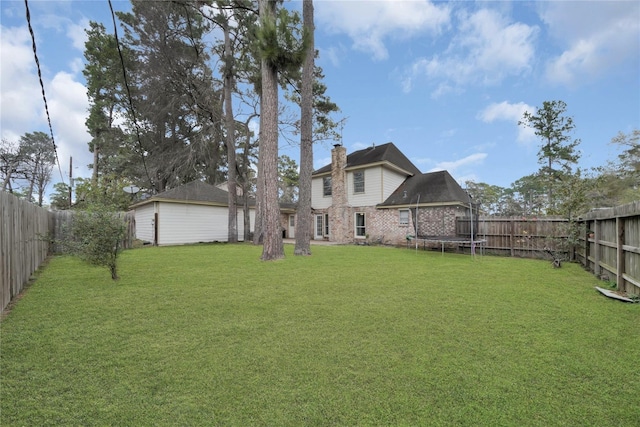 view of yard featuring a fenced backyard and a trampoline