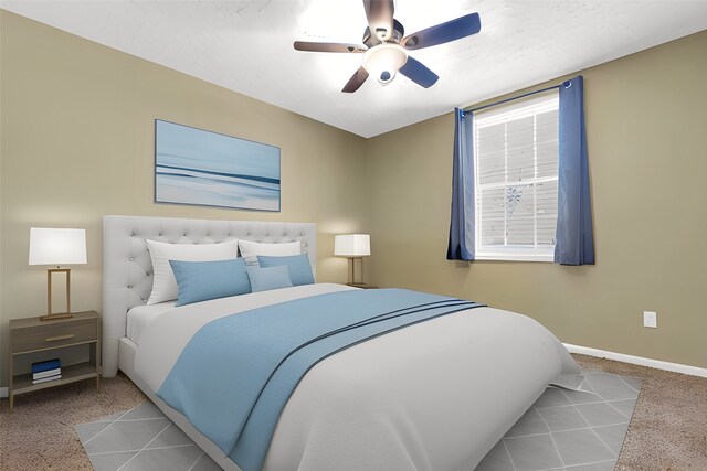 carpeted bedroom featuring baseboards and a ceiling fan