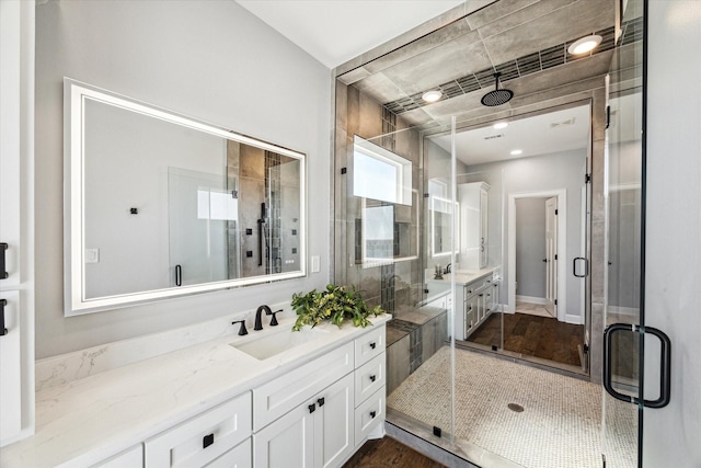 full bathroom with vanity and a shower stall