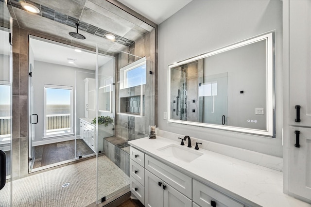 bathroom featuring a stall shower and vanity