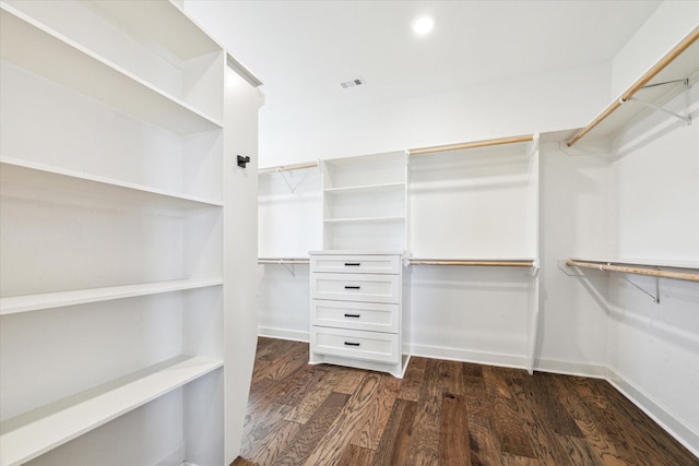 spacious closet featuring dark wood finished floors and visible vents