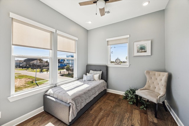 bedroom featuring visible vents, multiple windows, and wood finished floors