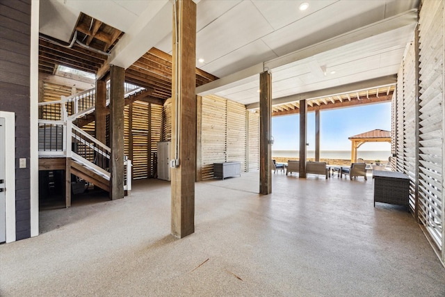 view of patio / terrace with stairway, outdoor dining area, and a water view