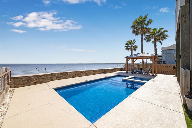 view of pool with a fenced in pool, a fenced backyard, a gazebo, a water view, and a patio area