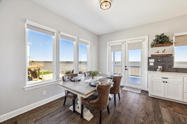 dining area with dark wood-style floors and baseboards