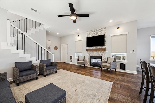 living room featuring visible vents, stairs, baseboards, and dark wood-style flooring