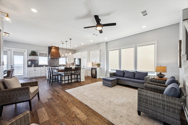 living room featuring recessed lighting, visible vents, a ceiling fan, and dark wood-style flooring