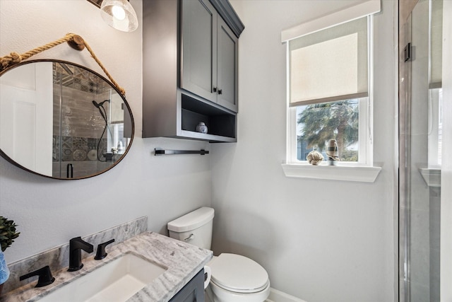 full bath with vanity, a shower stall, and toilet