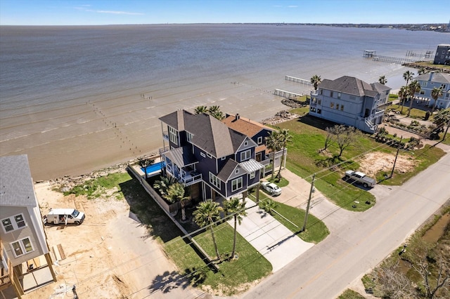 bird's eye view with a water view and a beach view