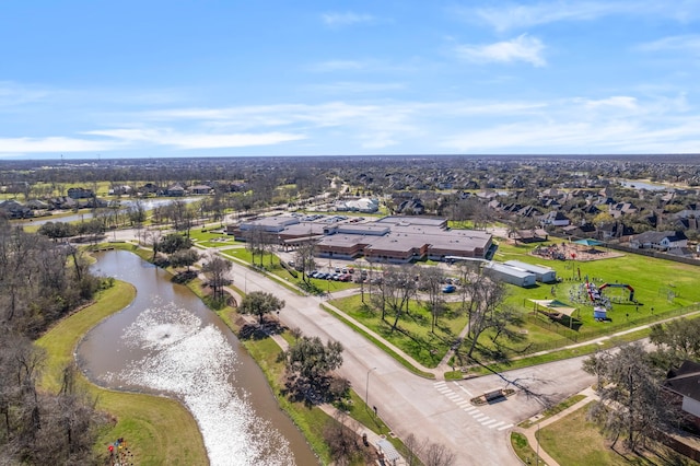 drone / aerial view featuring a water view and a residential view