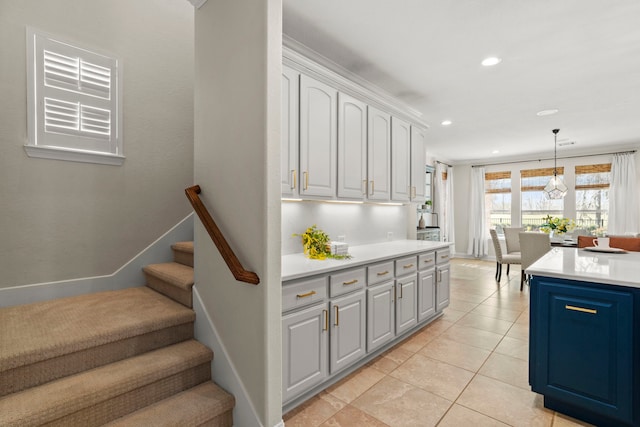 kitchen with pendant lighting, light tile patterned floors, recessed lighting, light countertops, and baseboards