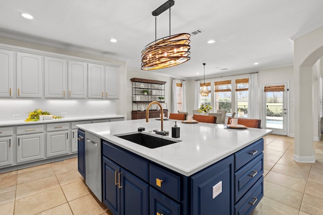 kitchen with ornamental molding, a sink, white cabinets, and blue cabinets