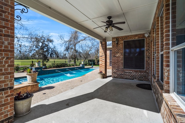 view of pool featuring a patio area, a fenced backyard, a fenced in pool, and a ceiling fan