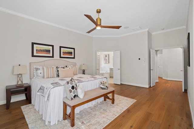 bedroom featuring baseboards, wood finished floors, visible vents, and crown molding