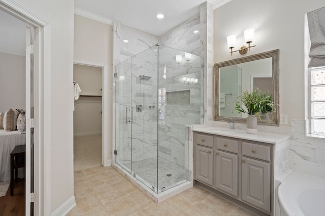 bathroom featuring a garden tub, ornamental molding, a shower stall, and vanity