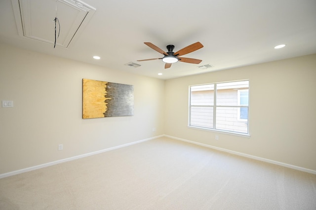 empty room with visible vents, recessed lighting, baseboards, light colored carpet, and attic access