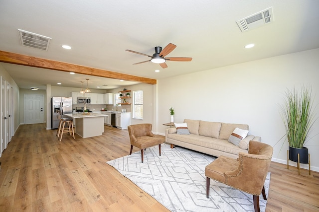 living room featuring visible vents, recessed lighting, light wood-type flooring, and baseboards