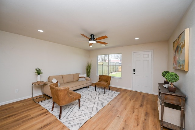 living room featuring recessed lighting, baseboards, and wood finished floors