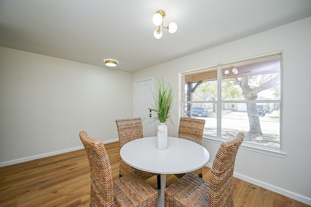 dining space featuring baseboards and wood finished floors