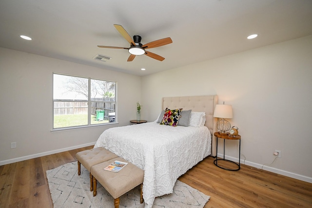 bedroom with recessed lighting, visible vents, baseboards, and wood finished floors