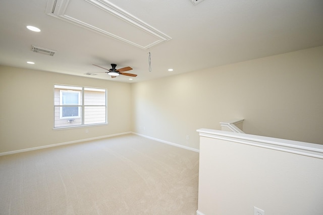 empty room featuring recessed lighting, baseboards, light carpet, and attic access