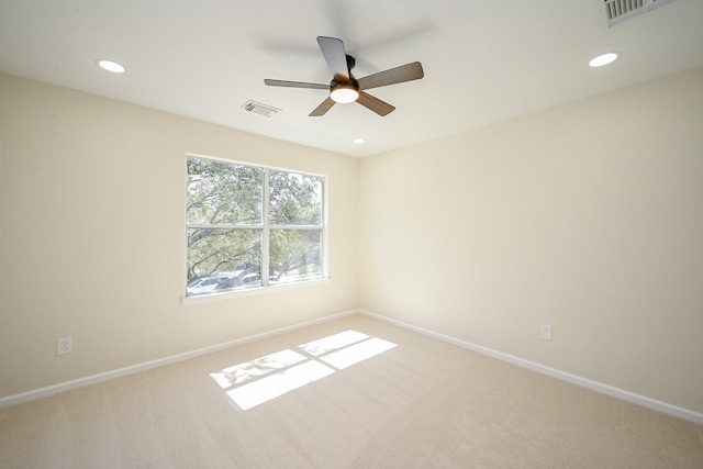 carpeted spare room with recessed lighting, visible vents, and baseboards