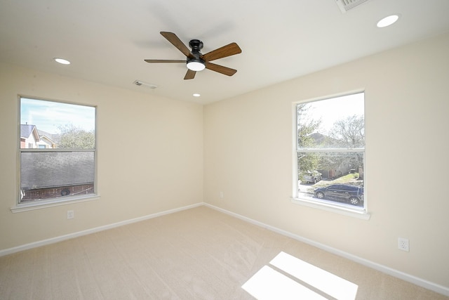 carpeted empty room with a ceiling fan, recessed lighting, visible vents, and baseboards