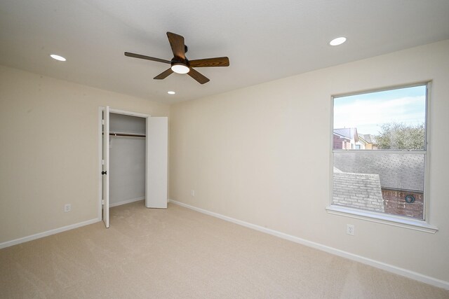 unfurnished bedroom featuring recessed lighting, light colored carpet, and baseboards