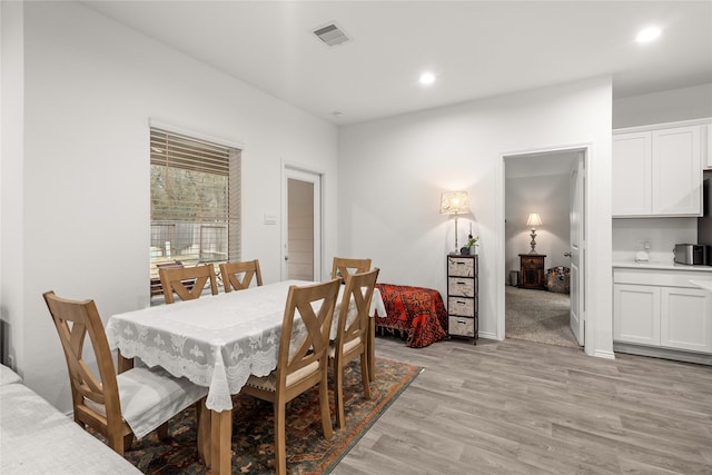 dining room with light wood-type flooring, visible vents, and recessed lighting