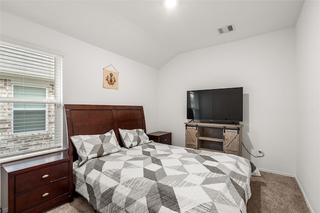 carpeted bedroom featuring lofted ceiling, visible vents, and baseboards