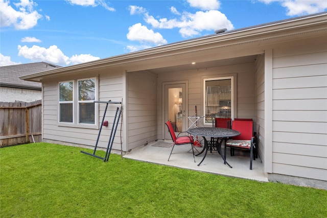 back of property with a patio area, fence, and a yard