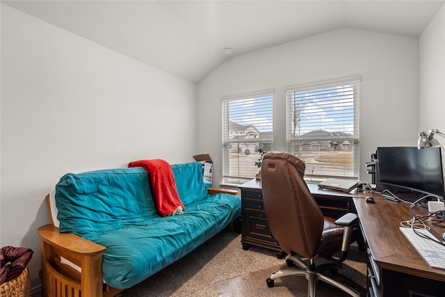 home office featuring lofted ceiling and carpet flooring