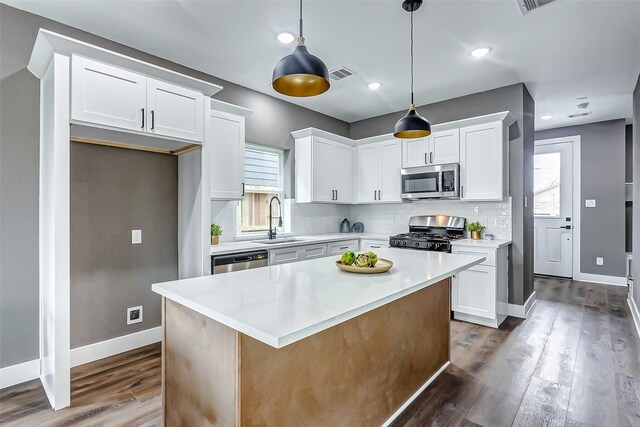 kitchen with white cabinets, visible vents, stainless steel appliances, and a sink