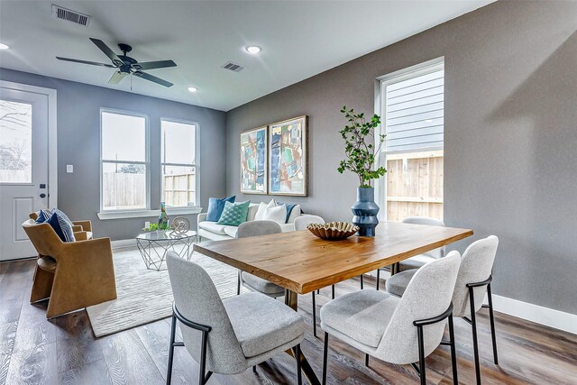 dining space featuring a ceiling fan, baseboards, visible vents, and wood finished floors