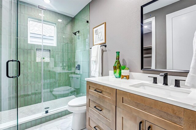 full bath with marble finish floor, a shower stall, toilet, and vanity