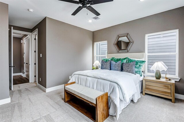 carpeted bedroom featuring recessed lighting, visible vents, ceiling fan, and baseboards