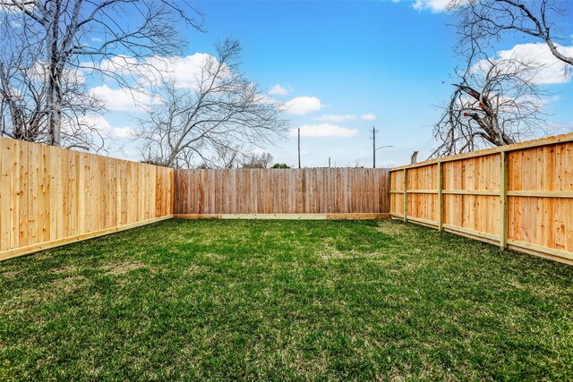 view of yard with a fenced backyard