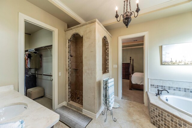 ensuite bathroom featuring tile patterned flooring, a spacious closet, crown molding, tiled shower, and a bath