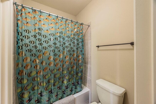 bathroom featuring toilet and shower / bath combo