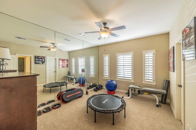 workout room featuring visible vents, ceiling fan, and carpet floors