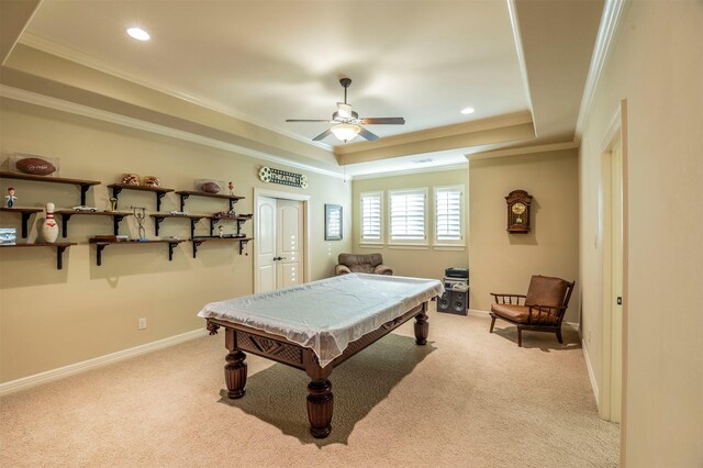 recreation room featuring a raised ceiling, crown molding, baseboards, and light carpet