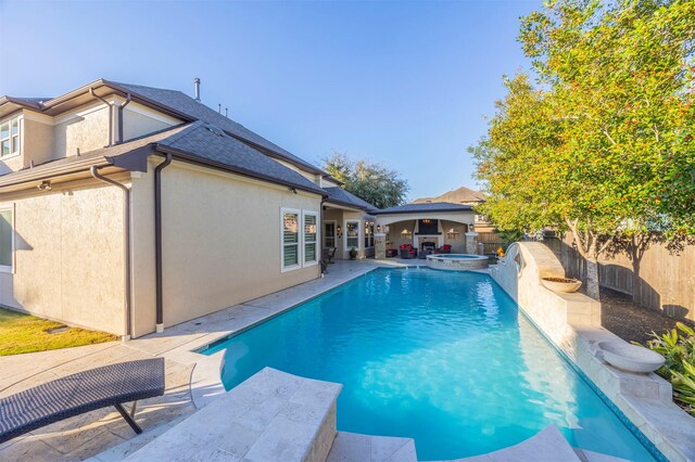 view of swimming pool featuring an in ground hot tub, a fenced backyard, a fenced in pool, and a patio